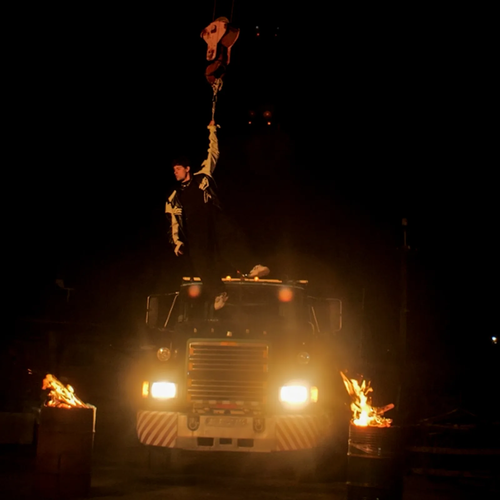 DISTEYO suspended from a crane above a truck between two fires